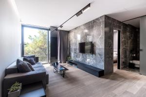 a living room with a couch and a fireplace at The Duke Boutique Suites in Athens