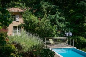 a swimming pool in front of a house at Le Clos d'Abrigeon in Aubenas