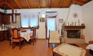 a kitchen and dining room with a table and a fireplace at NEFELI VILLA in Patitiri +23 photos