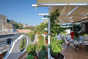 a balcony with a table and some plants at NEFELI VILLA in Patitiri