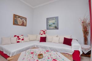 a living room with a couch and a rug at NEFELI VILLA in Patitiri