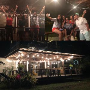 a group of people standing around a house at night at Tavarua Hotel in Montañita