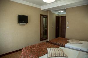 Postel nebo postele na pokoji v ubytování Yuksel Hotel