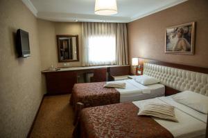 Postel nebo postele na pokoji v ubytování Yuksel Hotel