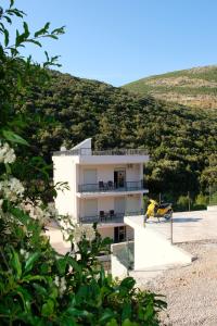 a building on the side of a hill at Trsteno Beach Apartments in Budva