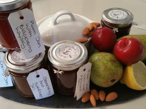 a plate of food with jars of apples and nuts at Wisteria Haze in Cranfield
