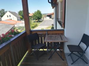 a table and chairs on a balcony with a view at Hanslbauernhof in Moosbach