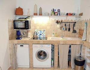 a kitchen with a washing machine and a sink at Charmante maisonnette au coeur de ville avec balcon - 70 m2 in Sète +10 photos