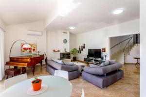 ein Wohnzimmer mit Möbeln und einem Klavier in der Unterkunft Luxury Villa Nadalina-Dicmo in Dugopolje