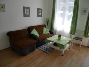 a living room with a couch and a table at Moskevská 40 in Karlovy Vary