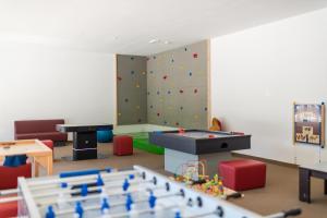 a play room with a climbing wall and a pool table at Hotel Lärchenhof in Solda