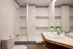 a bathroom with a toilet and a sink and a shower at Villa Ca na Magdalena - La Goleta Hotel de Mar & Villas in Port de Pollensa +14 photos