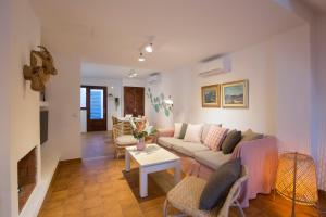 a living room with a couch and a table at Villa Ca na Magdalena - La Goleta Hotel de Mar & Villas in Port de Pollensa