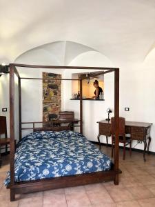 a bedroom with a bed and a desk and a mirror at LOVINGENOA DUCALE in Genoa