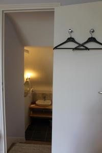 a bathroom with a sink and a mirror at Hôtel Les Empreintes in Saint-Évarzec