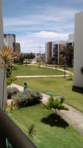 a view of a park with a person in the grass at Apartamento Iloa Residence in Barra de São Miguel