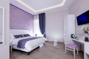 a bedroom with a large bed and a purple wall at St. Peter Fortytwo in Rome