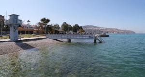 a dock in the water next to a body of water at Blue Casa in Koper