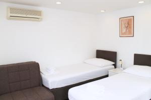 En eller flere senge i et værelse på Mito Rooms and Apartments