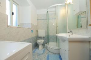 a bathroom with a sink and a toilet and a shower at Holiday HomeToni in Savar +32 photos