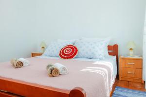 a bedroom with a bed with towels on it at Holiday HomeToni in Savar