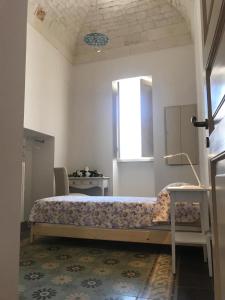 a bedroom with a bed and a window at Casa La Stella in Martina Franca