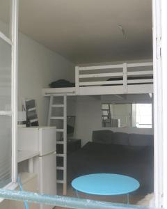 a dorm room with a bunk bed and a desk at Mini Loft Del Sarte CityCosy in Paris