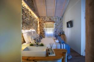 a bedroom with a bed and a sink in a room at Paxos Fairytales Lovenest 2 in Gaios