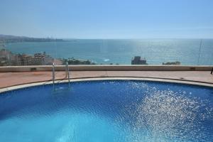 a large swimming pool with a view of the ocean at Hollywood Inn Boutique Hotel in Jounieh