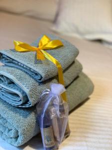 a pile of towels with yellow bows on top of them at Acquamarina in Gaeta