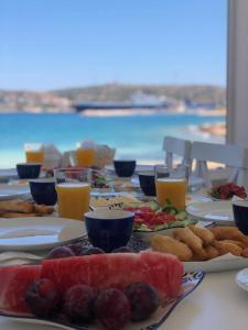 a table topped with plates of food and drinks at Alesya Otel in Çiftlikköyü