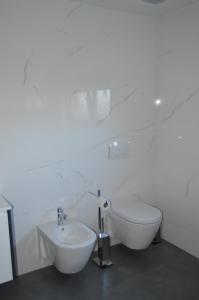 a white bathroom with a sink and a toilet at AL Ribeiro in Póvoa de Lanhoso +9 photos