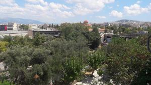 a view of a city with trees and buildings at Thissio View Design Apartment in Athens