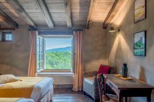 a bedroom with a bed and a large window at Domaine du Roc in Saou