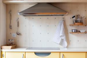 a kitchen with a hood over a kitchen counter at Apartment in the heart of Bled with views in Bled +23 photos