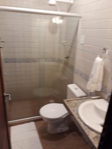 a bathroom with a toilet and a sink at Pousada Igrejinha dos Carneiros in Tamandaré