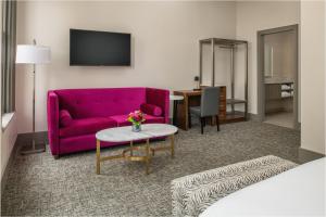 a living room with a purple couch and a table at Harlow Hotel in Portland