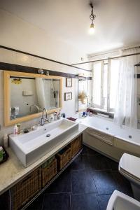 uma casa de banho com uma grande banheira e um grande lavatório. em Appartamento La Rondine em Pesaro