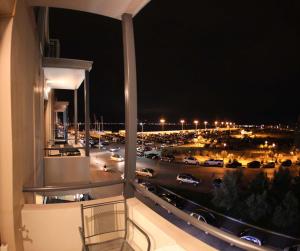 a balcony with a view of a city at night at Vida Residential Apartments in Nafplio