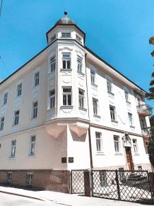 a white building with a clock tower on top of it at Luxury apartments only for Business Travel in Salzburg