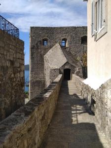an alleyway in a castle with a stone wall at Studio Apartman GRACIJA in Herceg-Novi +7 photos