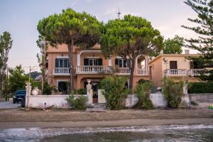 a house with trees in front of it at Villa marina " G " in Argasi