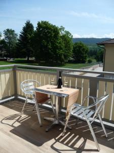 a table and two chairs sitting on a deck at La casa di Terlago in Terlago