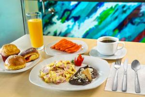 a table with plates of breakfast food and a cup of coffee at Life Hotel in Oaxaca City