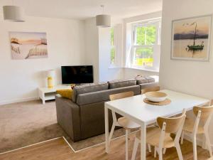 a living room with a couch and a table at The Martins in Peterborough