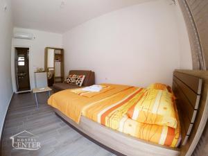a bedroom with a bed and a couch in it at Hostel Center in Ulcinj