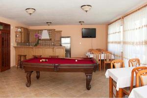 a room with a pool table in a restaurant at Villa Butterfly in Nová Lesná