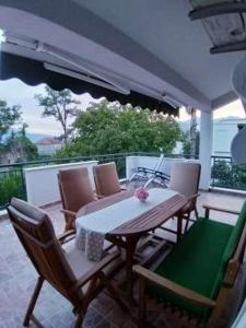 a patio with a table and chairs on a balcony at Apartmani Stipanic Tivat in Tivat