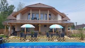 una casa con piscina frente a ella en Kids' Paradise House, en Balatonboglár