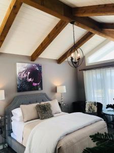 a bedroom with a bed and a ceiling with beams at Seafoam Lodge in Little River